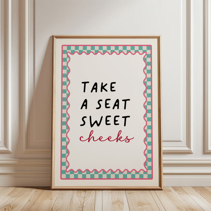 Aqua bathroom print with funny quote, take a seat sweet cheeks and a chequered border. Funky wall art