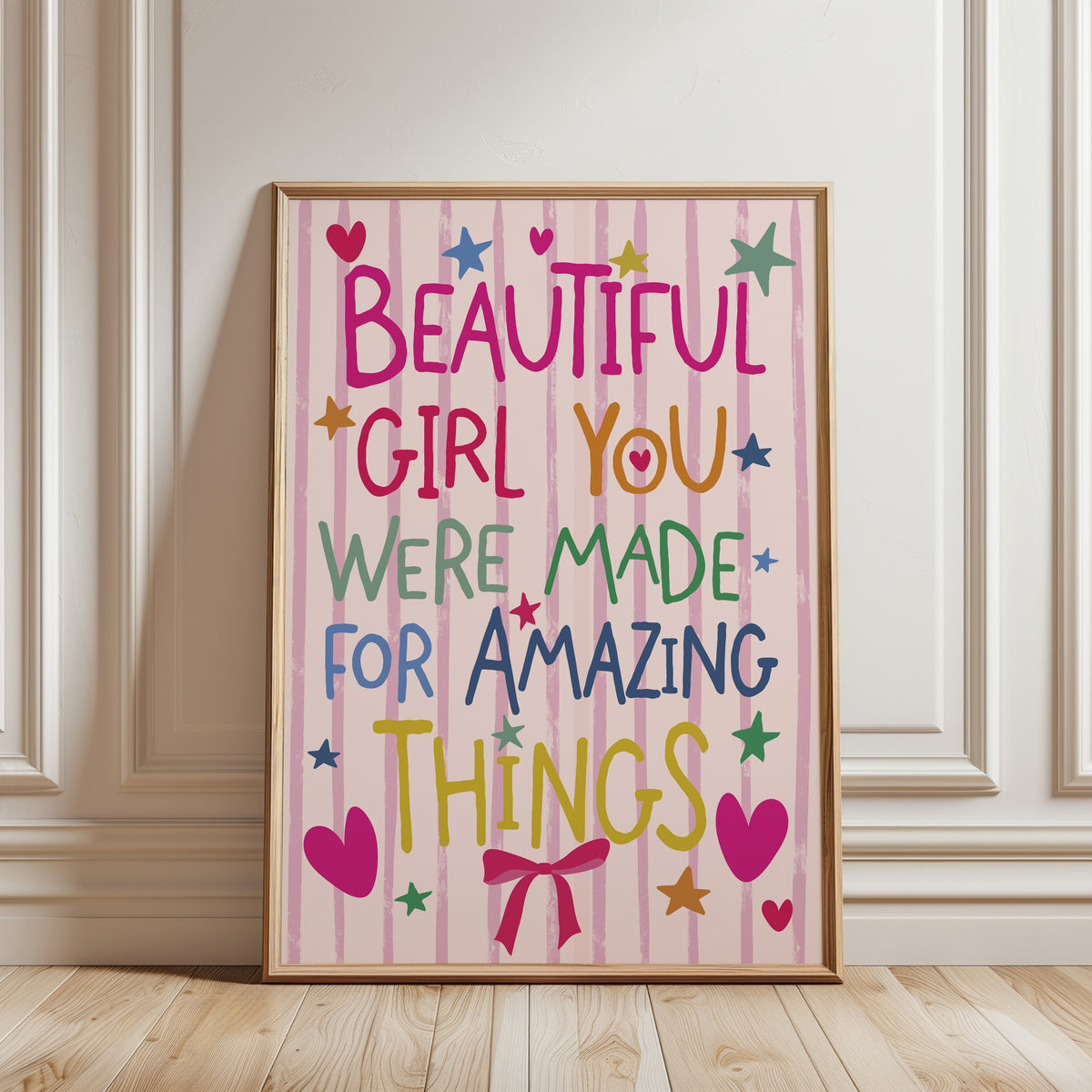 Girls affirmation wall art print with quote "Beautiful girl you were made for amazing things" in a playful font and in colourful shades, on a pink stripe background with illustrations of love hearts stars and a pink bow. Funky wall art for girls room