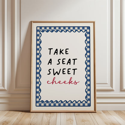 Blue bathroom print with funny quote, take a seat sweet cheeks and a chequered border. Funky wall art