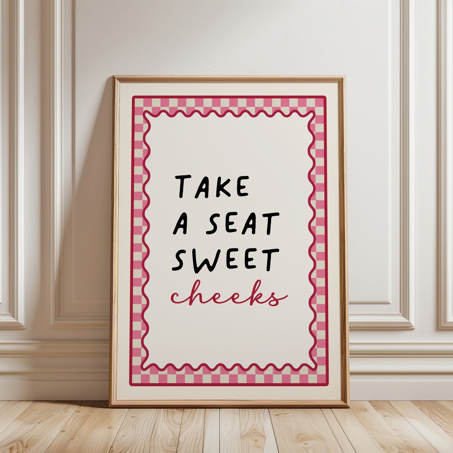 Bright Pink bathroom print with funny quote, take a seat sweet cheeks and a chequered border. Funky wall art