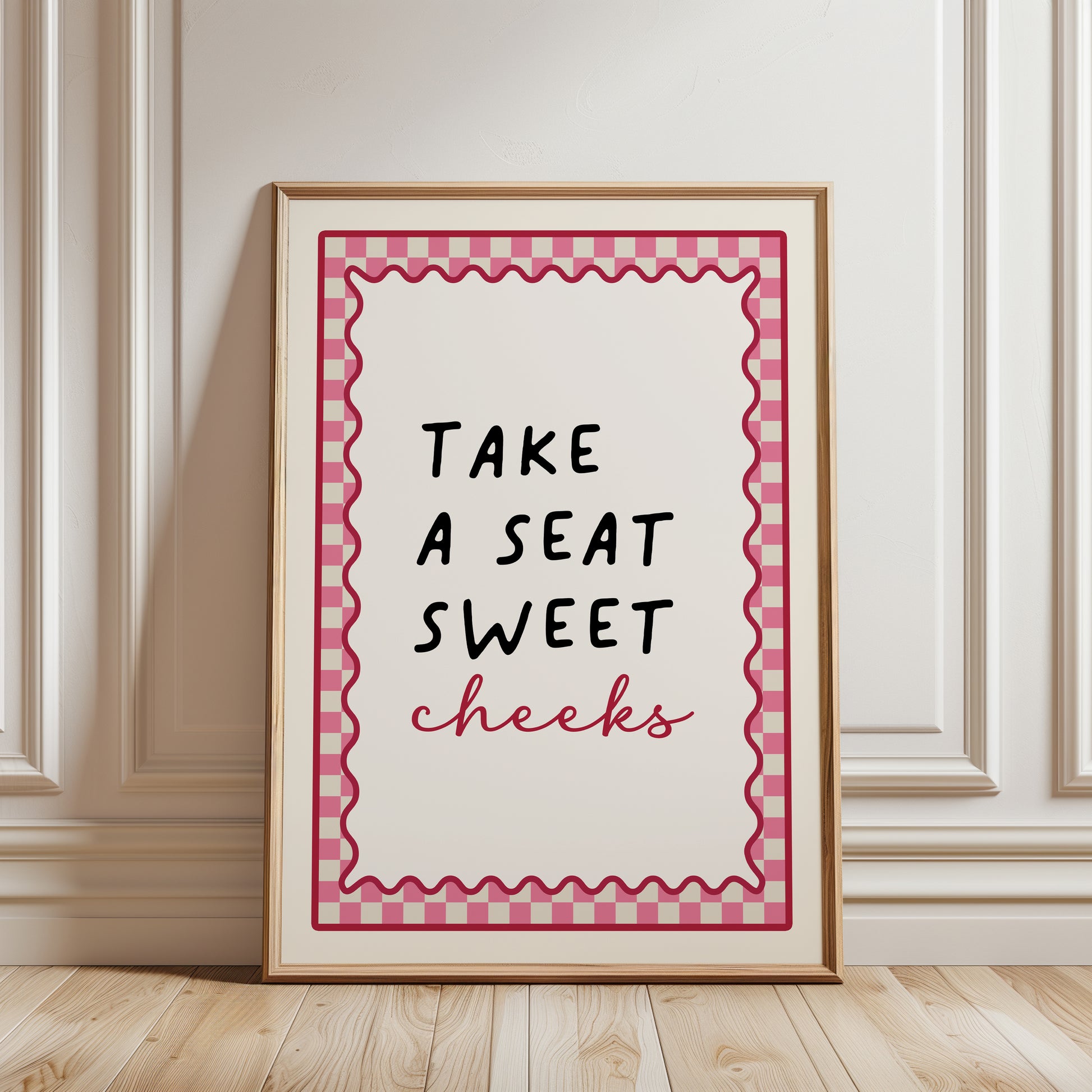 Bright Pink bathroom print with funny quote, take a seat sweet cheeks and a chequered border. Funky wall art