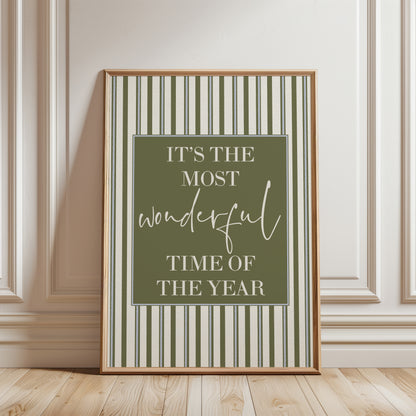 Christmas print on an olive green and beige stripe background with festive quote reading "It's the most wonderful time of the year", this is modern Christmas home decor