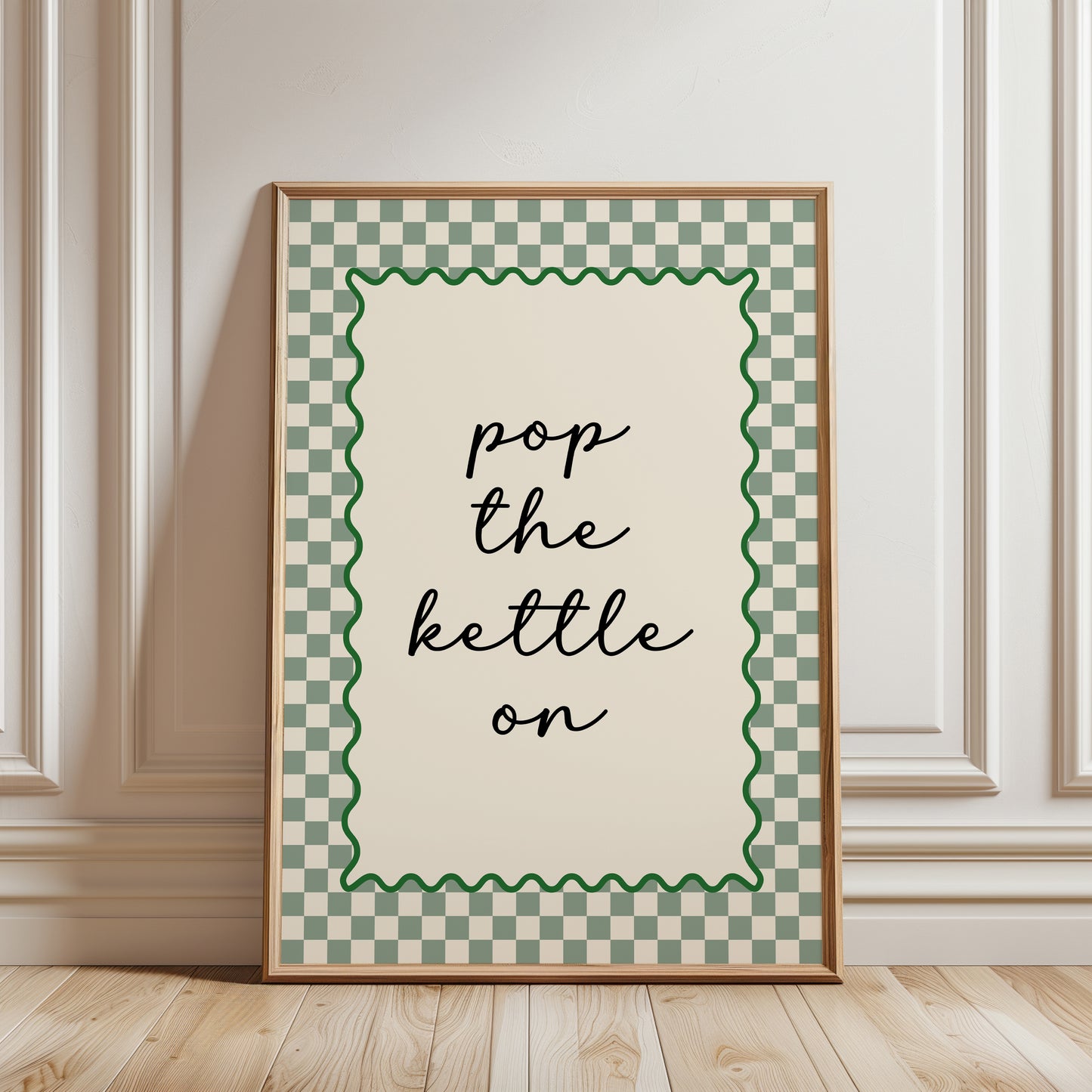Modern kitchen print in sage green and beige, funny quote "pop the kettle on" in black text with a sage green chequered border