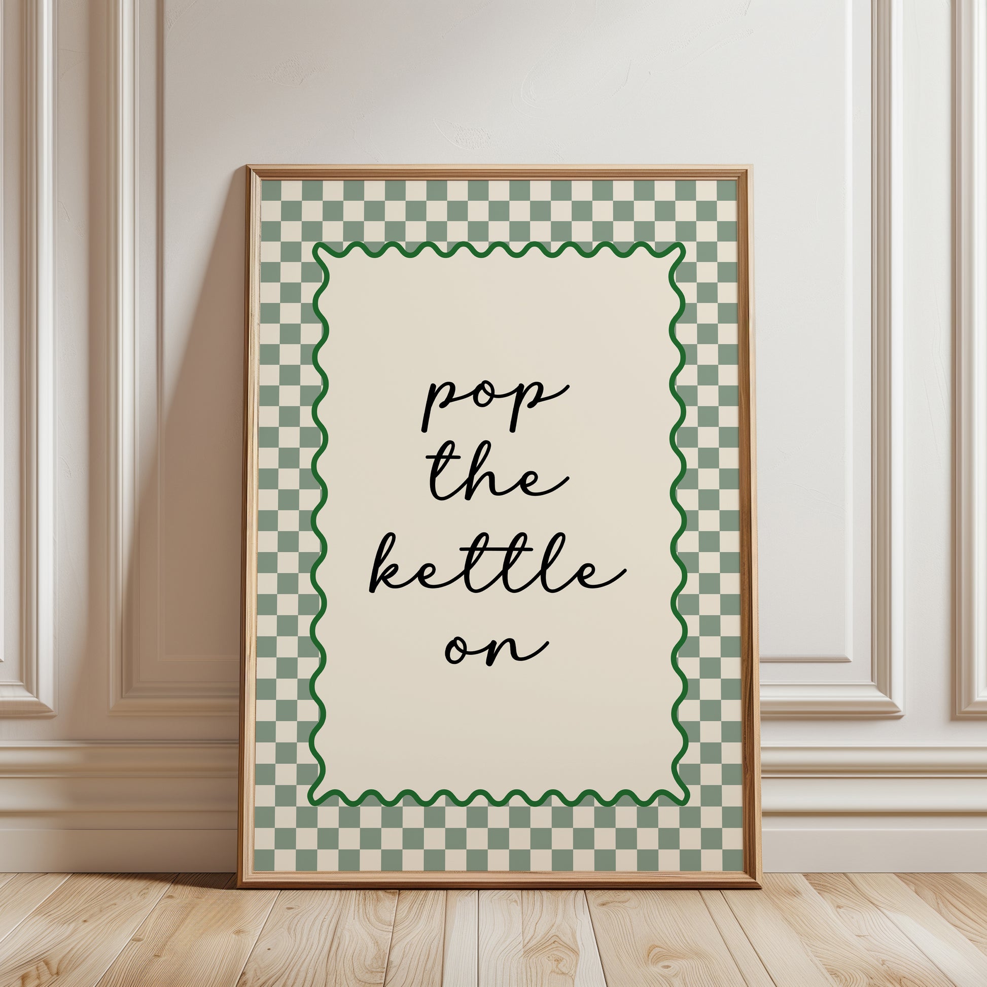 Modern kitchen print in sage green and beige, funny quote "pop the kettle on" in black text with a sage green chequered border