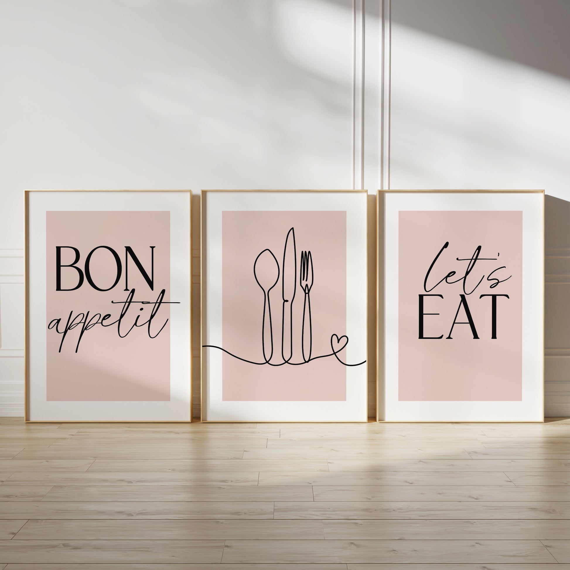 Pink kitchen wall art set, set of three prints with quote BON APPETIT, LETS EAT and line drawn cutlery with love heart on the middle print