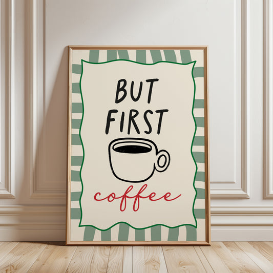 An unframed typographic art print. The print reads “BUT FIRST coffee” with a black coffee cup illustration, a green border, and a cream background.