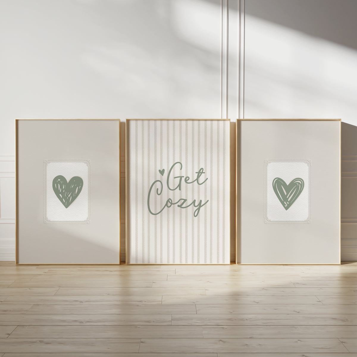 sage green wall art prints, featuring sage green love hearts on beige embossed paper effect backgrounds and quote "get cozy" ina script font in sage green on a textured look stripe background in neutral beige