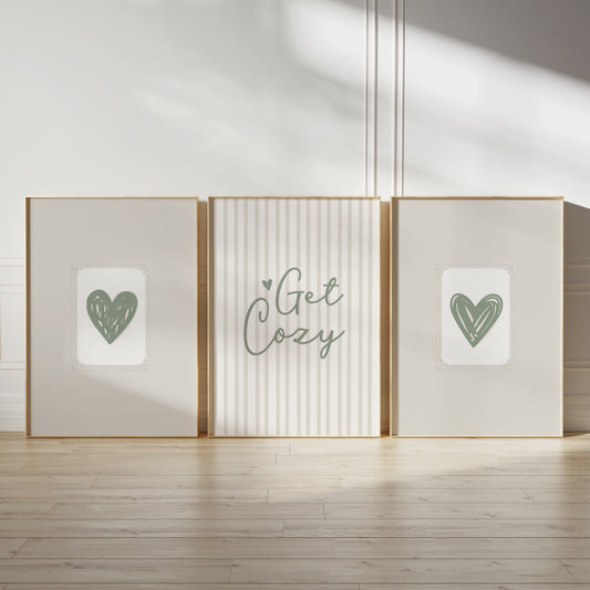 sage green wall art prints, featuring sage green love hearts on beige embossed paper effect backgrounds and quote "get cozy" ina script font in sage green on a textured look stripe background in neutral beige