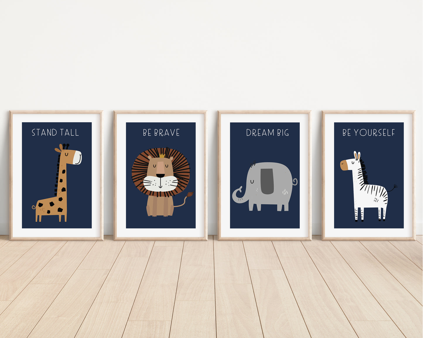 Four unframed children's art prints. The prints feature cartoon animals and motivational phrases: a giraffe reading 'STAND TALL,' a lion reading 'BE BRAVE,' an elephant reading 'DREAM BIG,' and a zebra reading 'BE YOURSELF.
