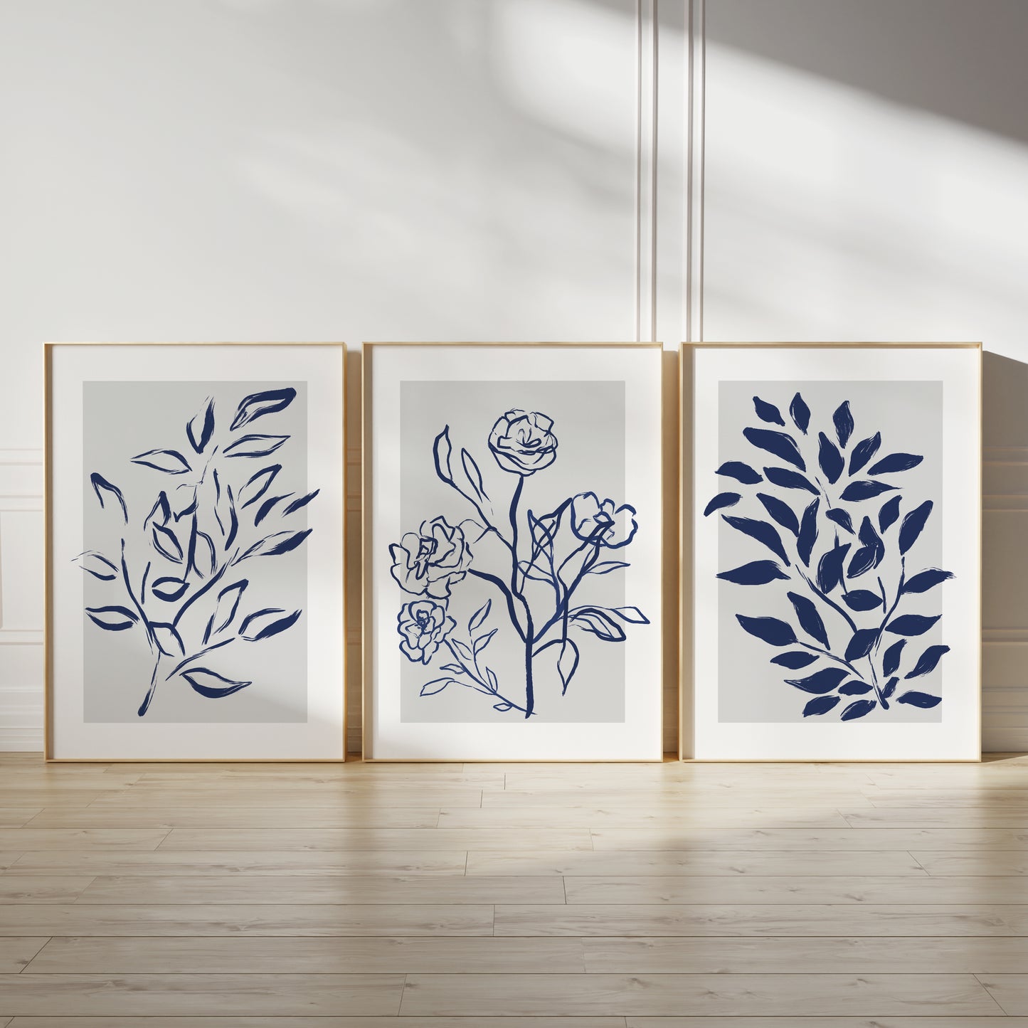 Blue home wall art prints, ink drawn plants in blue on grey watercolour backgrounds with white borders, living room decor