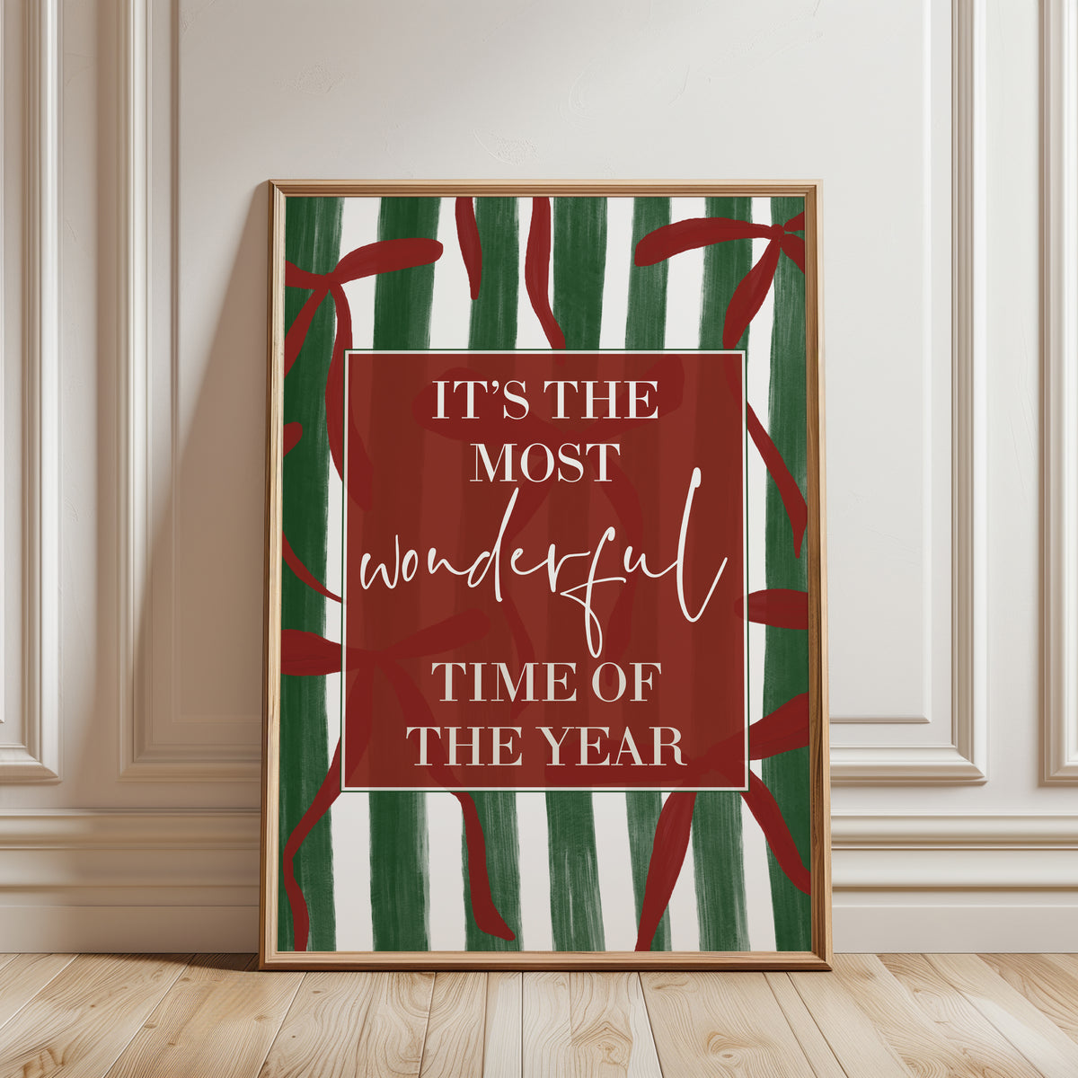 Modern Christmas home decor, wall art print with festive quote "it's te most wonderful time of the year" on a green stripe background with red bows
