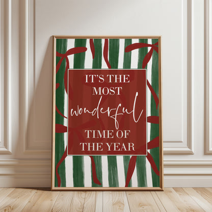 Modern Christmas home decor, wall art print with festive quote "it's te most wonderful time of the year" on a green stripe background with red bows