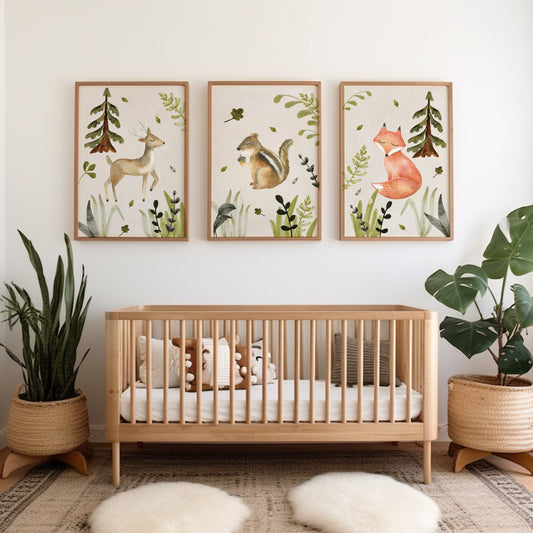 Three unframed woodland animal art prints. The prints show a deer, a squirrel, and a fox with trees and foliage in soft earthy colors.